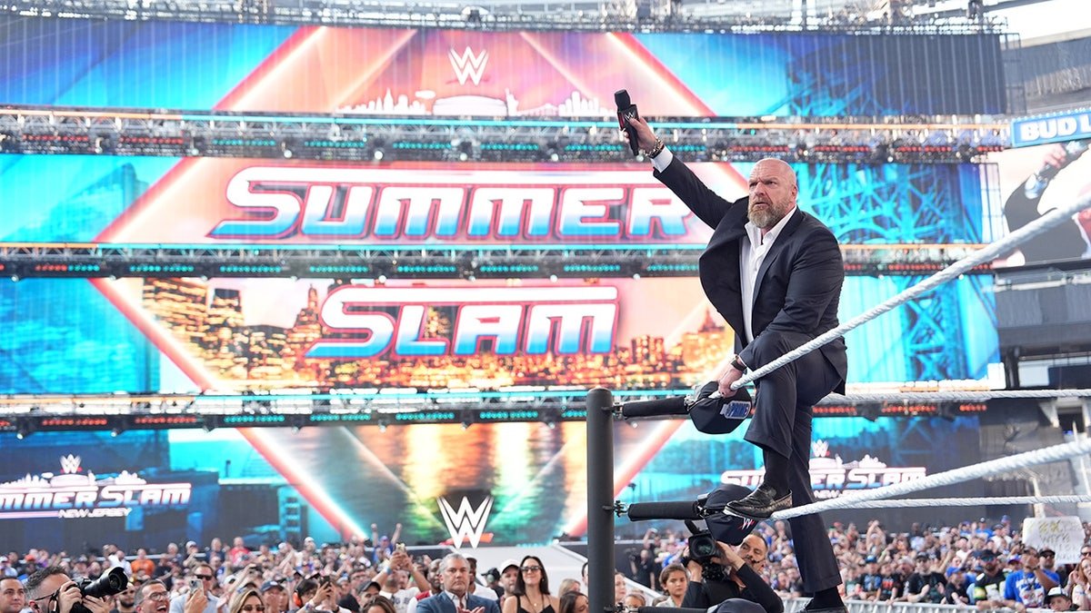 Triple H celebrates with the crwod