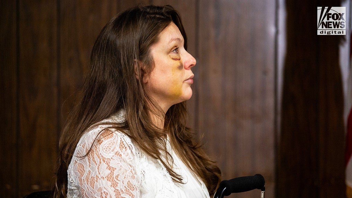 Holly, a victim in the viral July 26 brawl in Cincinnati, listens as Sen. Bernie Moreno speaks