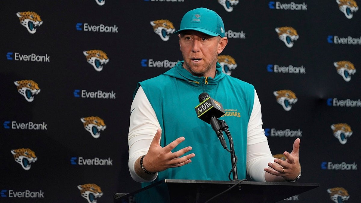 Liam Coen talks to reporters