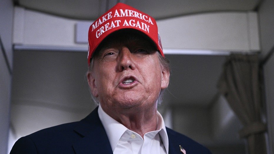 Trump wearing a MAGA red hat