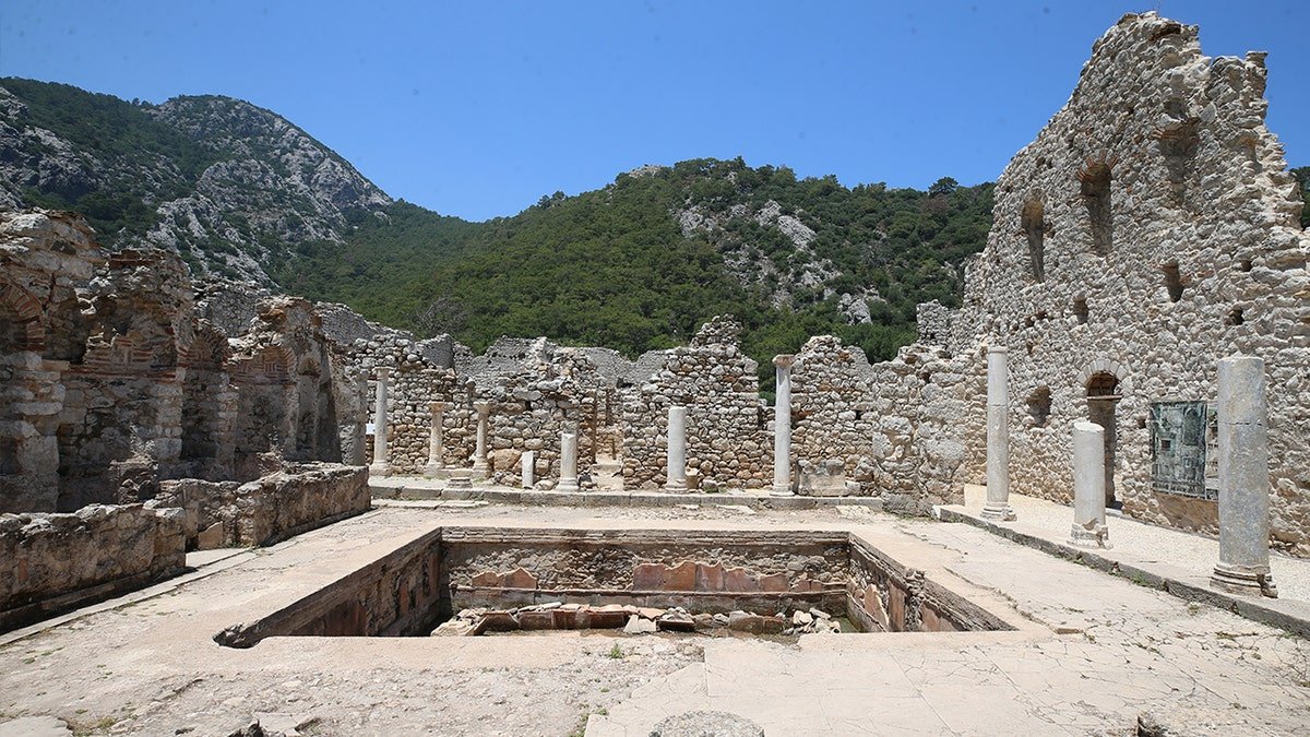 Image of ruined church with pillar, stone walls