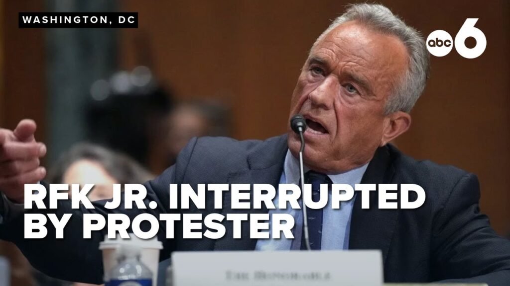 RFK Jr.’s opening statements disrupted by protester during tense Senate finance committee hearing RFK Jr.’s opening statements disrupted by protester during tense Senate finance committee hearing