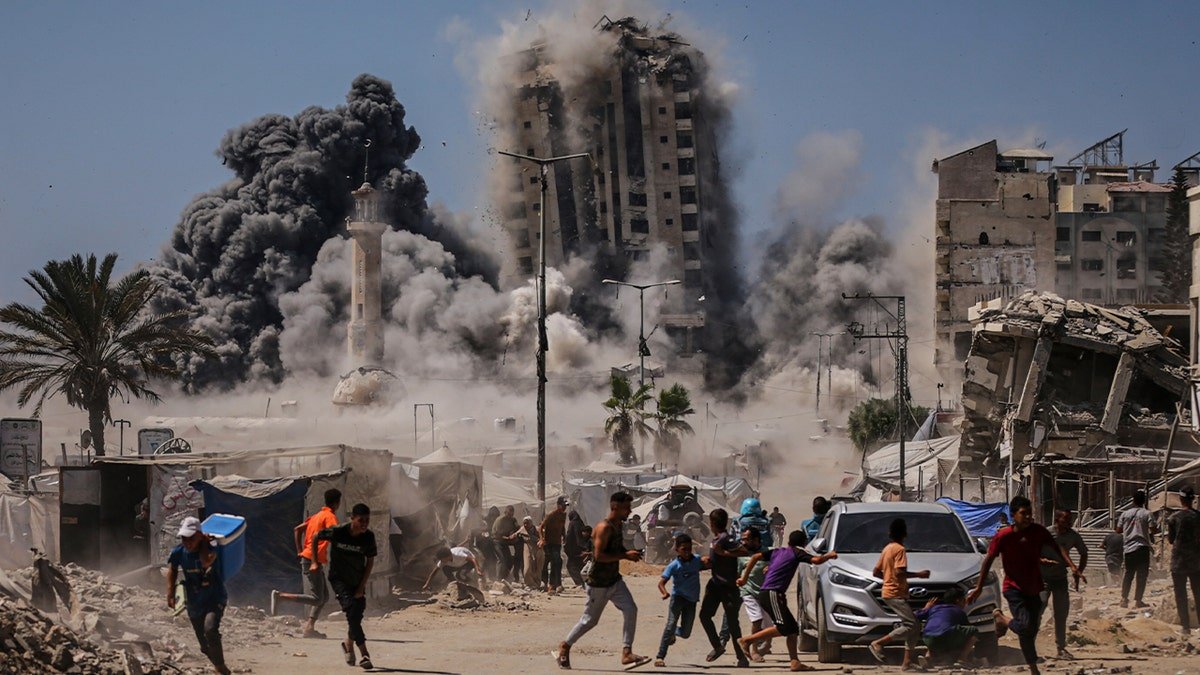 Palestinians run during Israeli airstrike