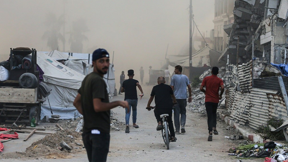 Palestinians run after Israeli airstrike in Gaza City