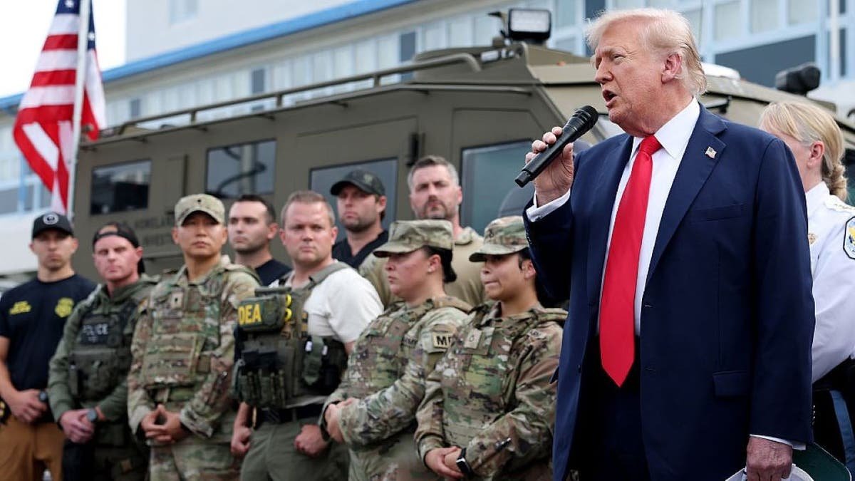 Trump standing with federal law enforcement.