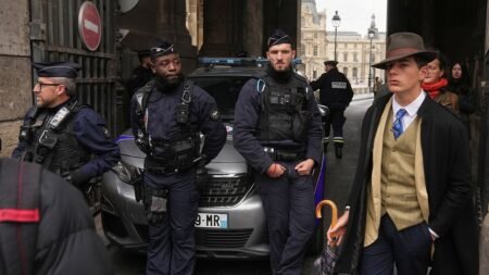 Mystery man in dapper suit goes viral after appearing in Louvre heist investigation photo Mystery man in dapper suit goes viral after appearing in Louvre heist investigation photo
