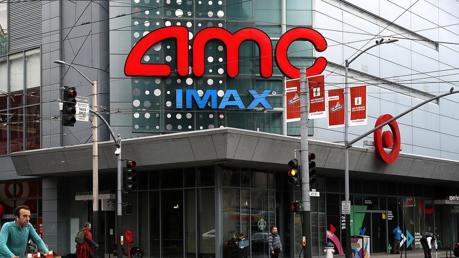 A cyclist rides his bike by an AMC theatre in San Francisco.