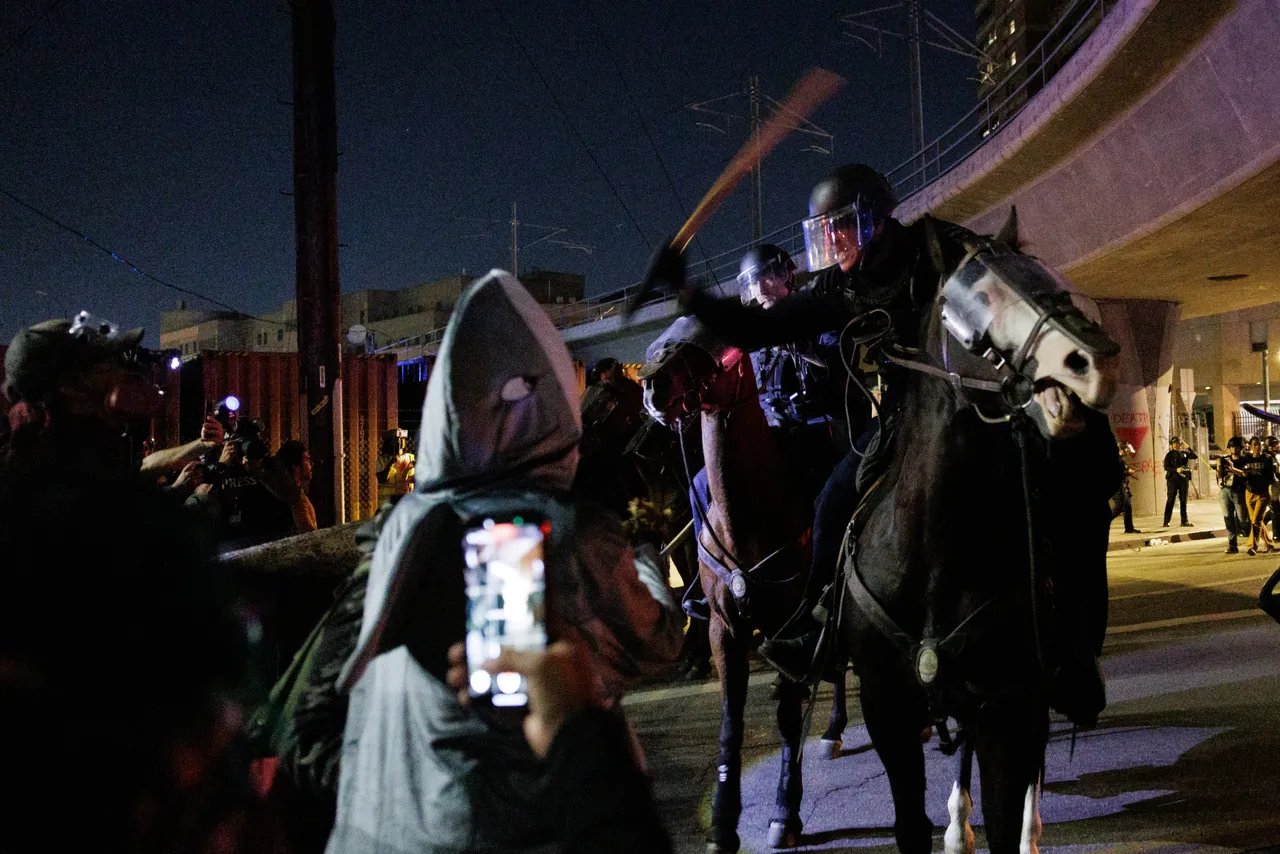 LOS ANGELES, CALIFORNIA - OCTOBER 18: Protesters and mounted Los Angeles Police Department officers clash outside the Metropolitan Detection Center after an unlawful assembly was declared during the