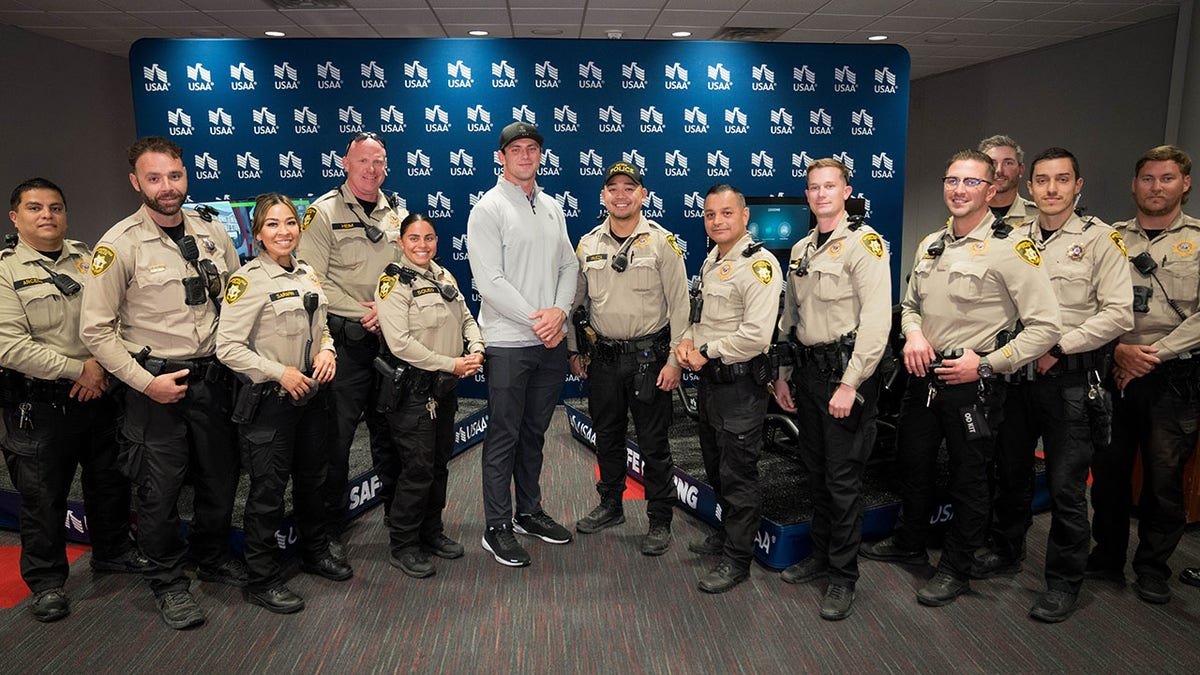 Brock Bowers with police officers