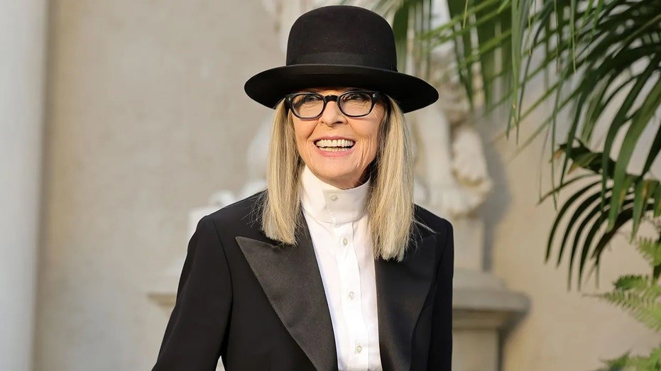 Diane Keaton in a black hat smiling