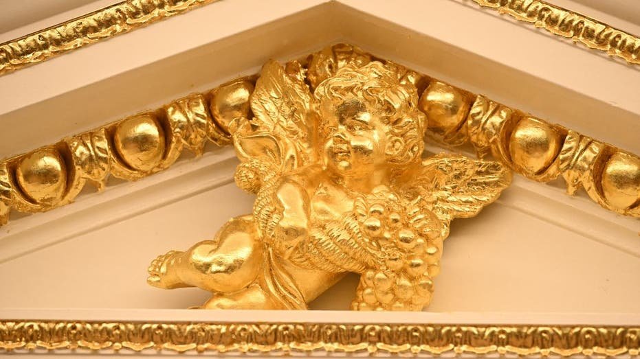 A golden cherub in the Oval Office