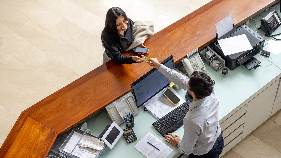 A woman paying for a hotel