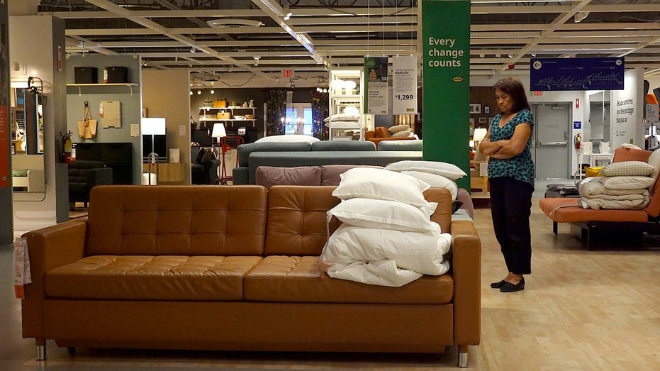 A customer shops for furniture at an IKEA store.