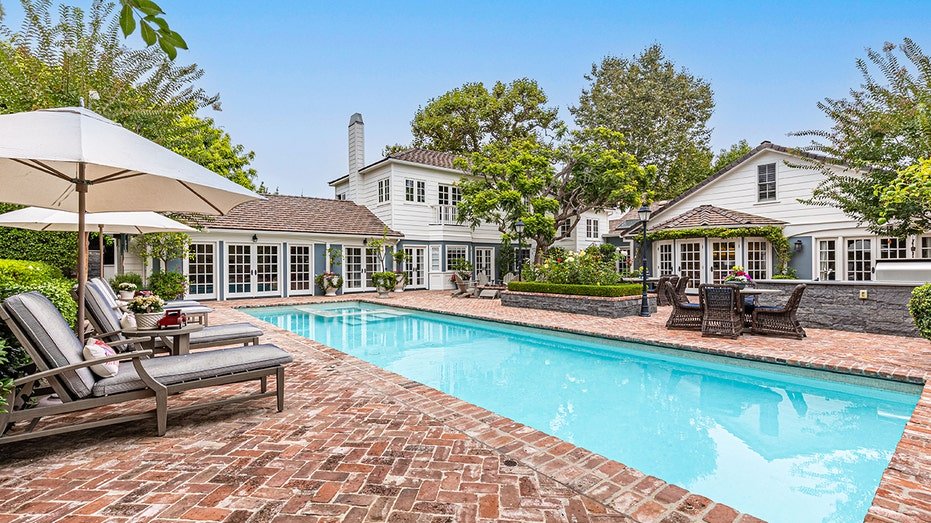 The backyard also features a swimming pool.