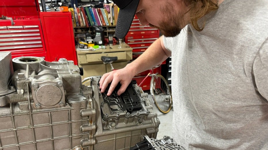 A student works on a McLaren 720S transmission.