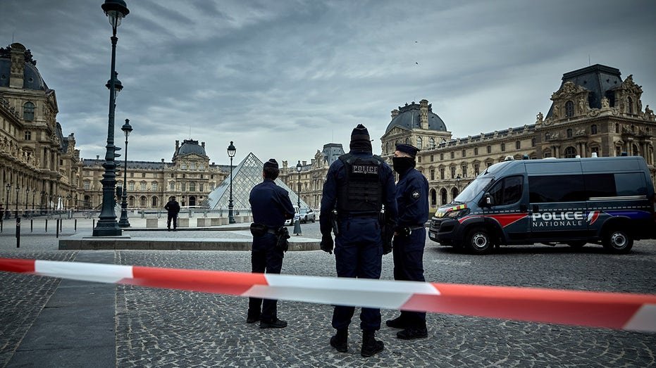 French Police officers seal off the entrance to the Louvre Museum