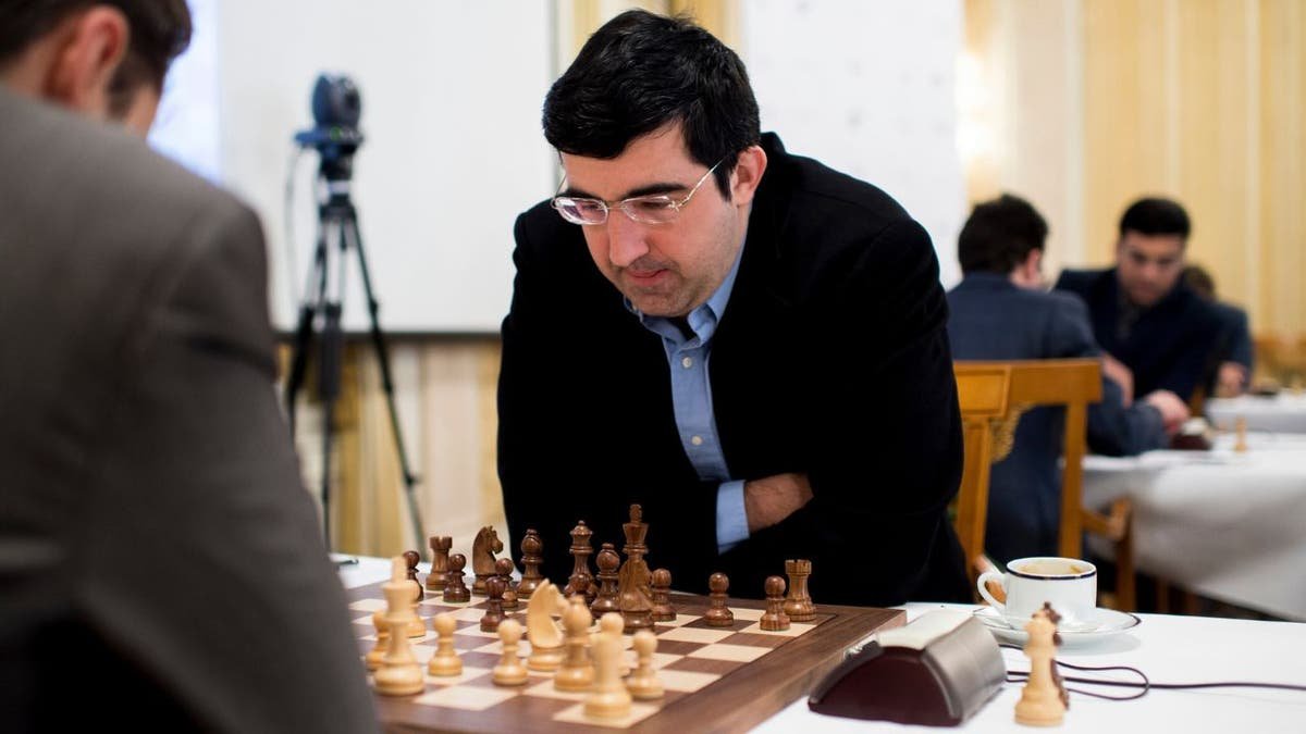 Vladimir Kramnik leans over a chessboard during a match in Zurich, Switzerland.