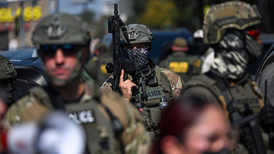 federal officers geared up walking in streets