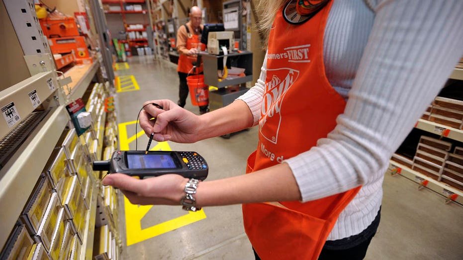 Home Depot employee using a handheld device.