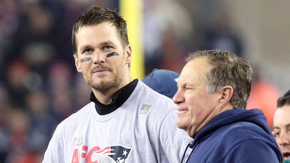Tom Brady stands with Bill Belichick