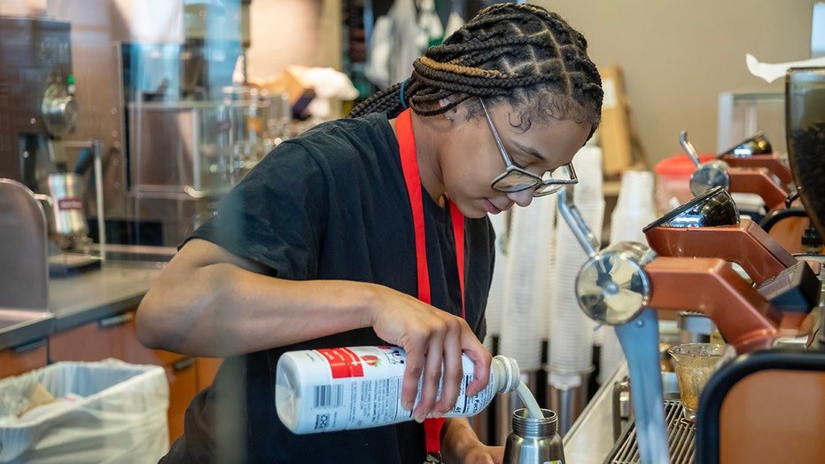 Starbucks barista makes a drink